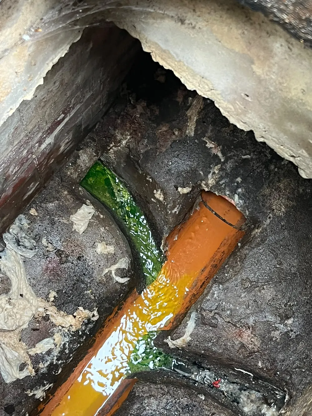 Damaged drainage pipe within an inspection chamber