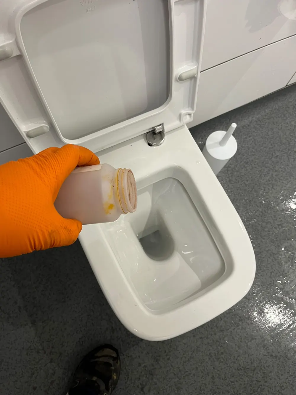 Toilet drain treatment being applied