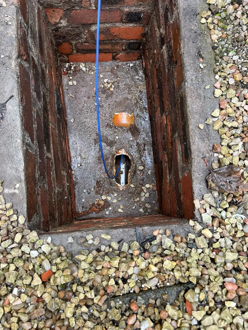 Open drain chamber with inspection camera cable
